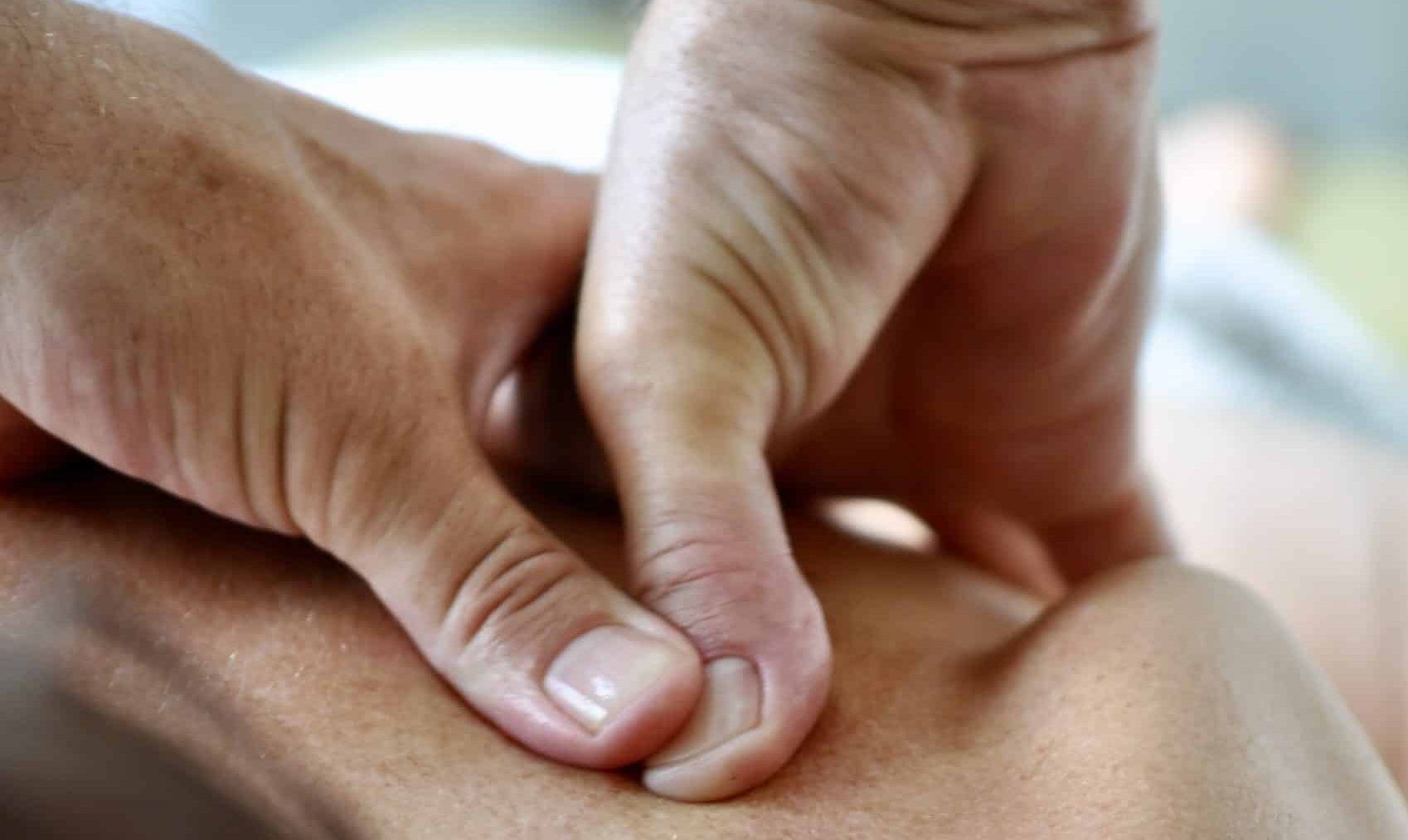 Tim Young performing deep tissue massage on upper back